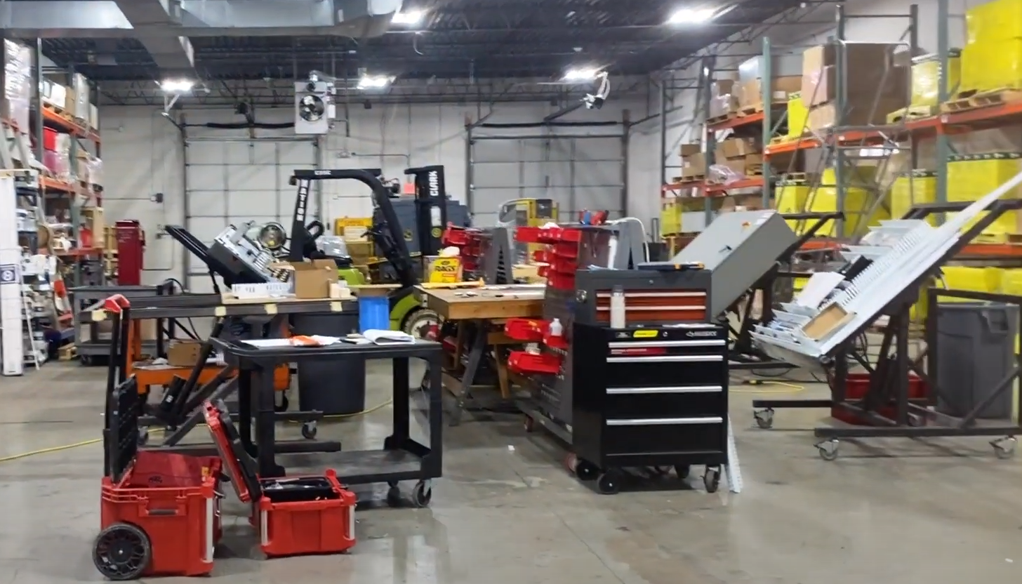 Busy shop floor at Apex Industrial Automation's Bensonville, IL control panel fabrication shop, with multiple panels in the process of fabrication.