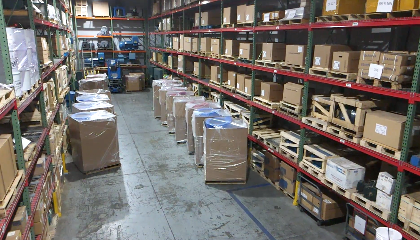 Aerial view of Apex Industrial Automation's stockroom filled with brand-name industrial electric motors on shelves for industrial parts distribution.