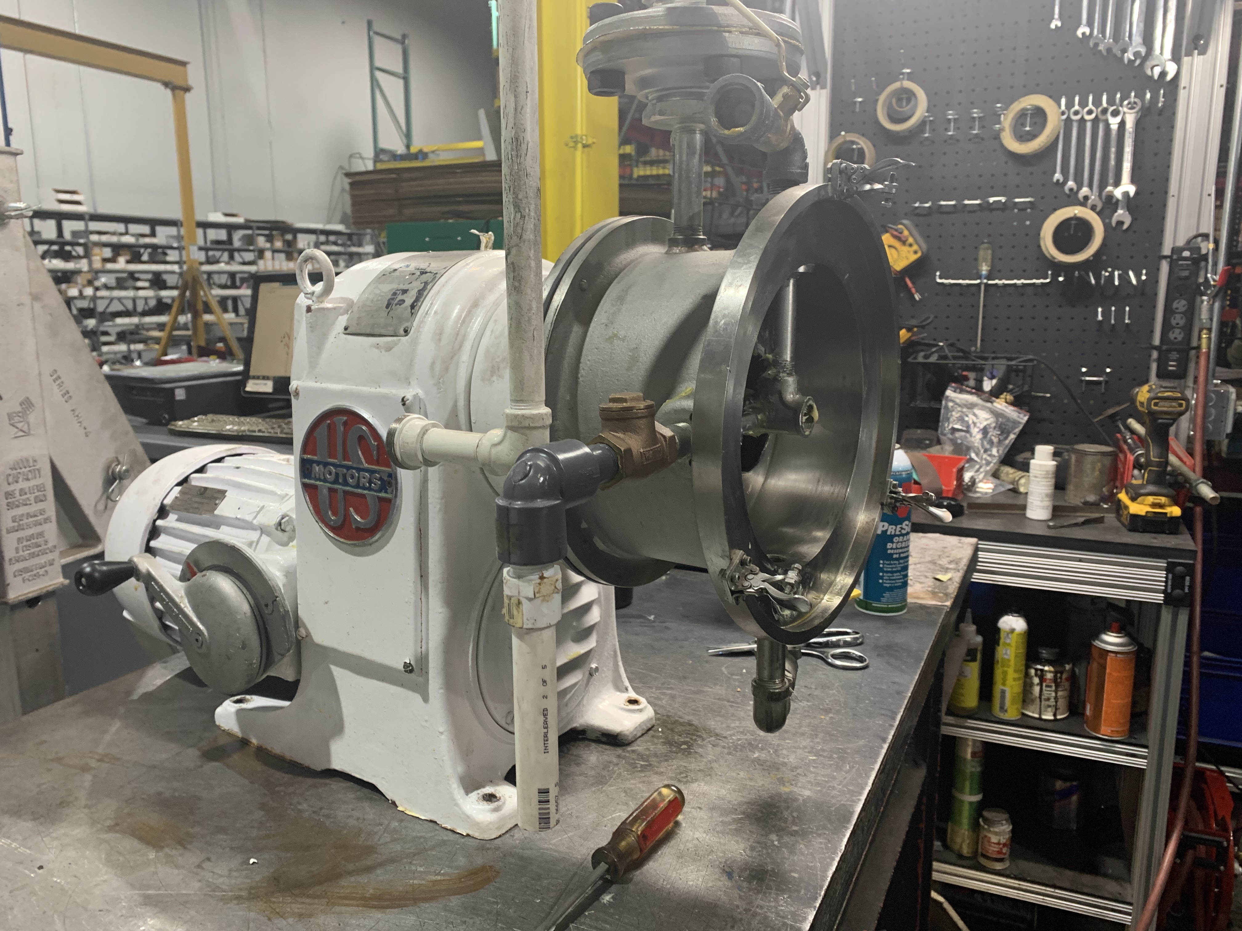 White custom explosion-proof electric motor integrated with gearbox and pump components at Apex Industrial Automation, illustrating specialty repair services.
