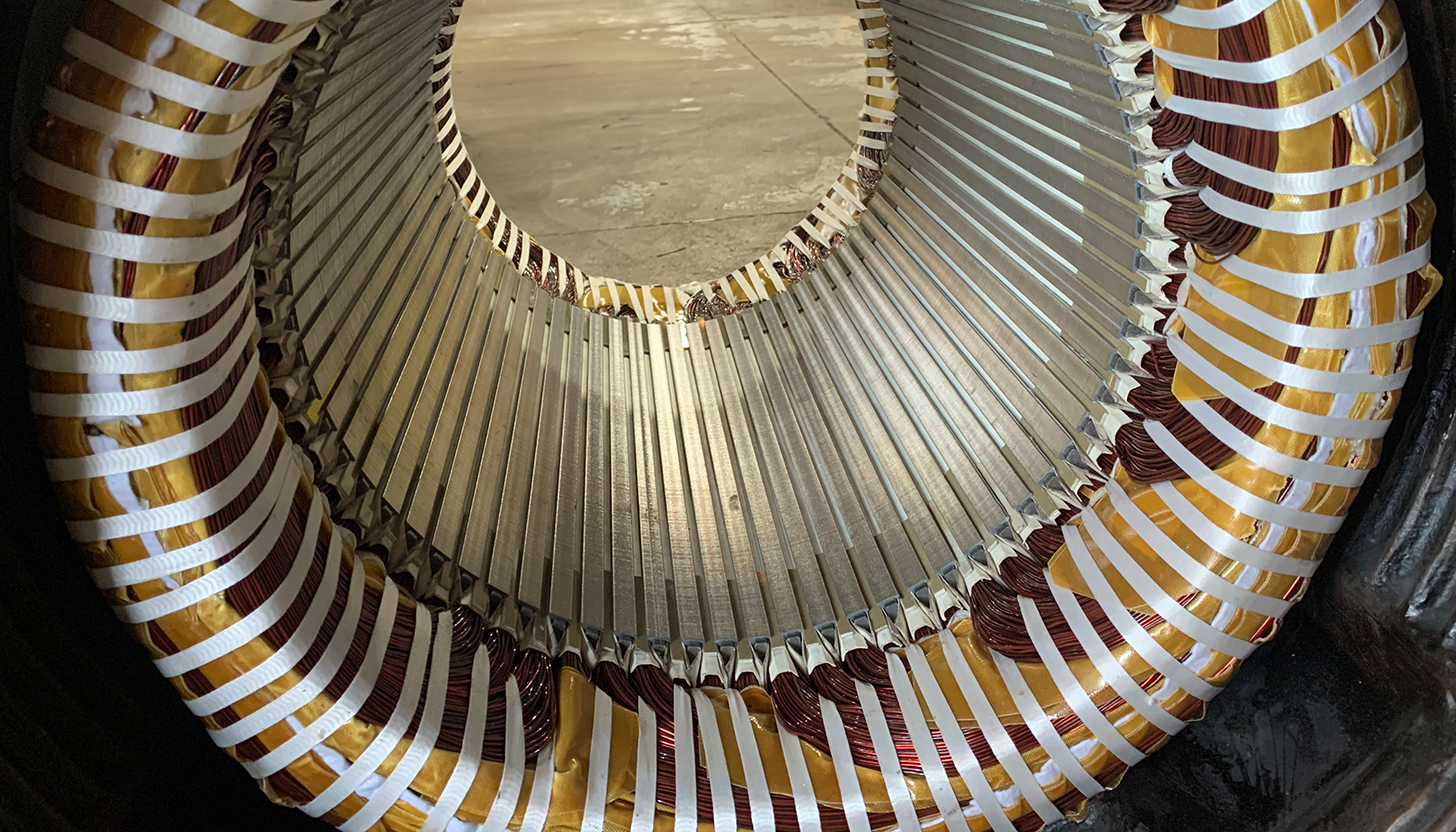 Close-up view through the stator of a finished motor rewind, highlighting intricate winding work at Apex Industrial Automation.