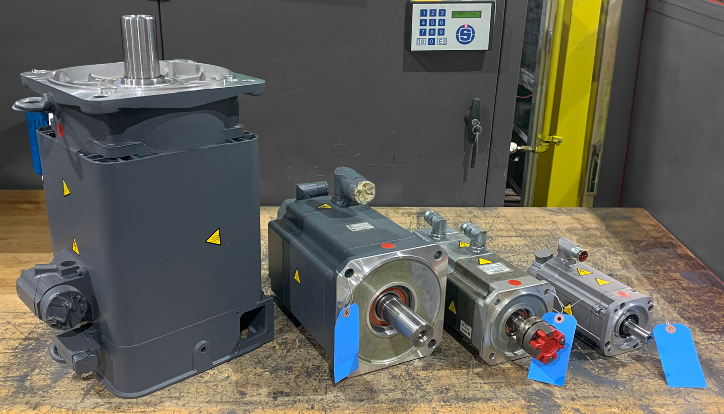 Four SIEMENS servo motors arranged from largest to smallest on a table at Apex Industrial Automation, showcasing our servo motor repair capabilities.