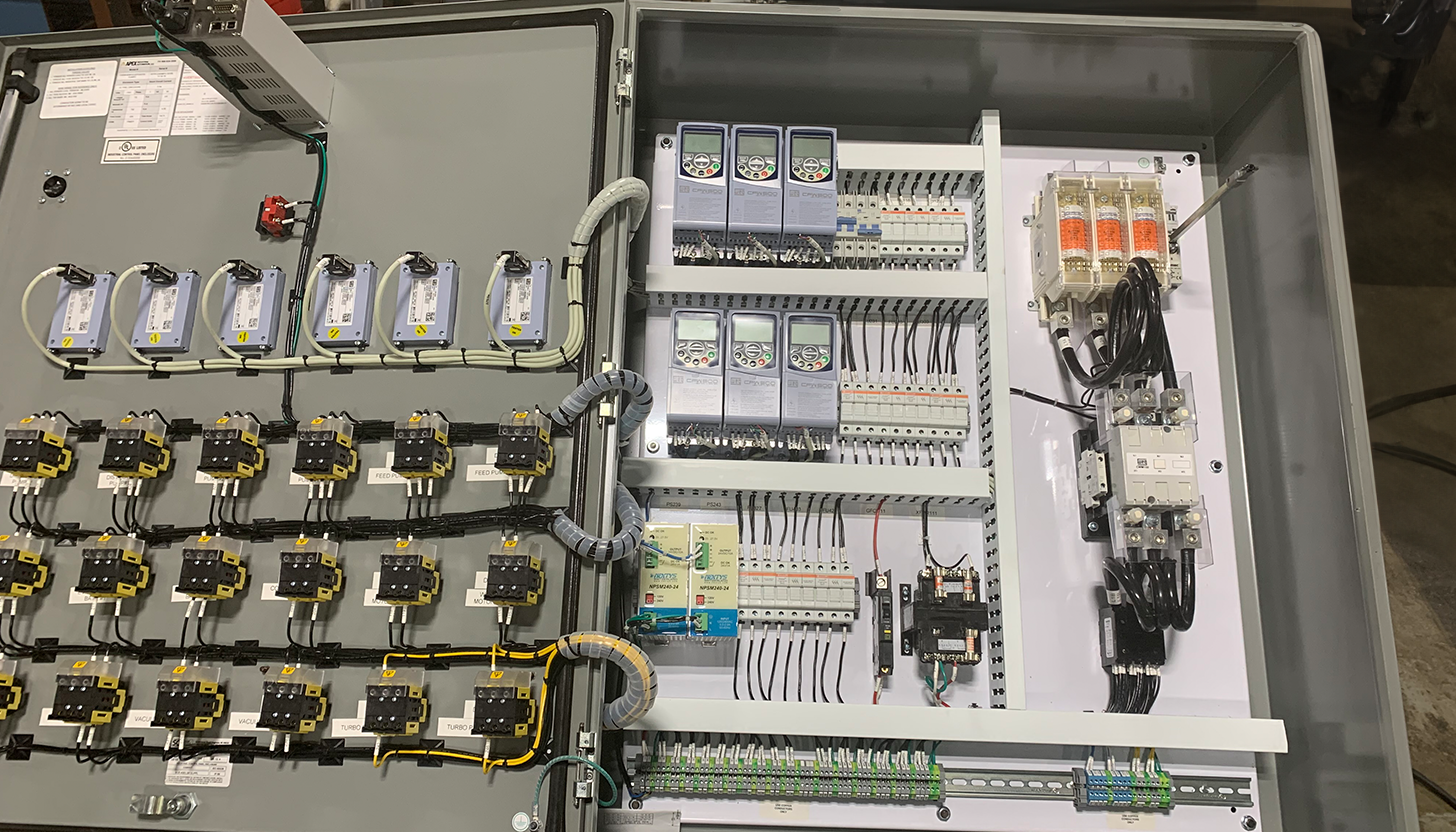 Inside view of an industrial control panel showing detailed wiring and layout by Apex Industrial Automation.