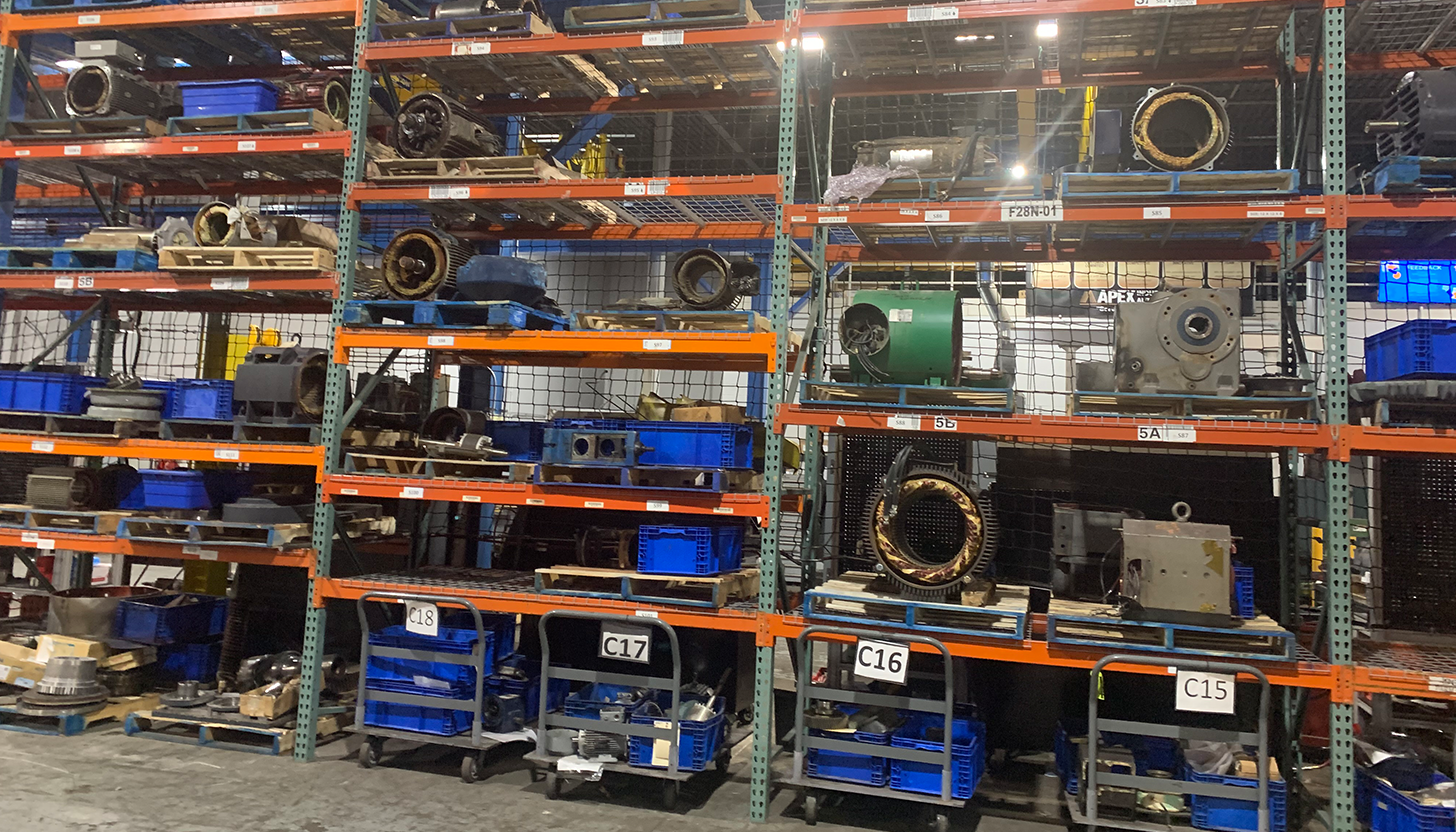 AC/DC electric motors lined up on shelves in Apex Industrial Automation's warehouse, ready for repair or delivery.